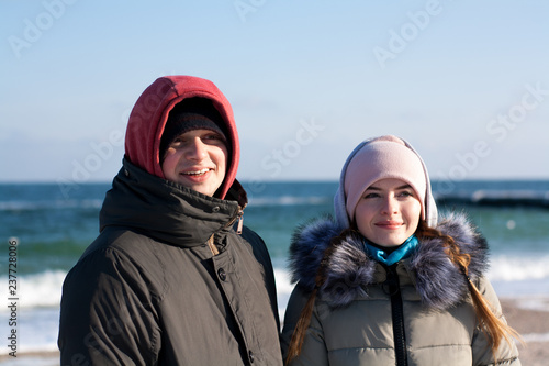 Man and woman walk on the beach and have a good time. Happy couple