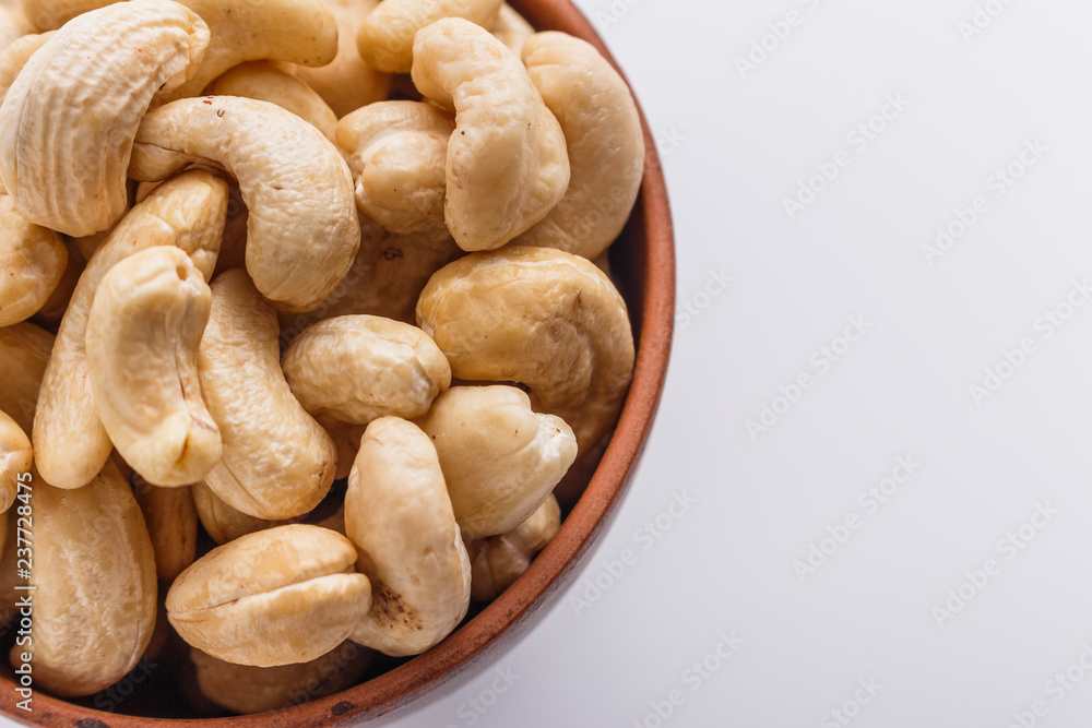 cashew nuts on a white acrylic background cashew nuts on a white acrylic background