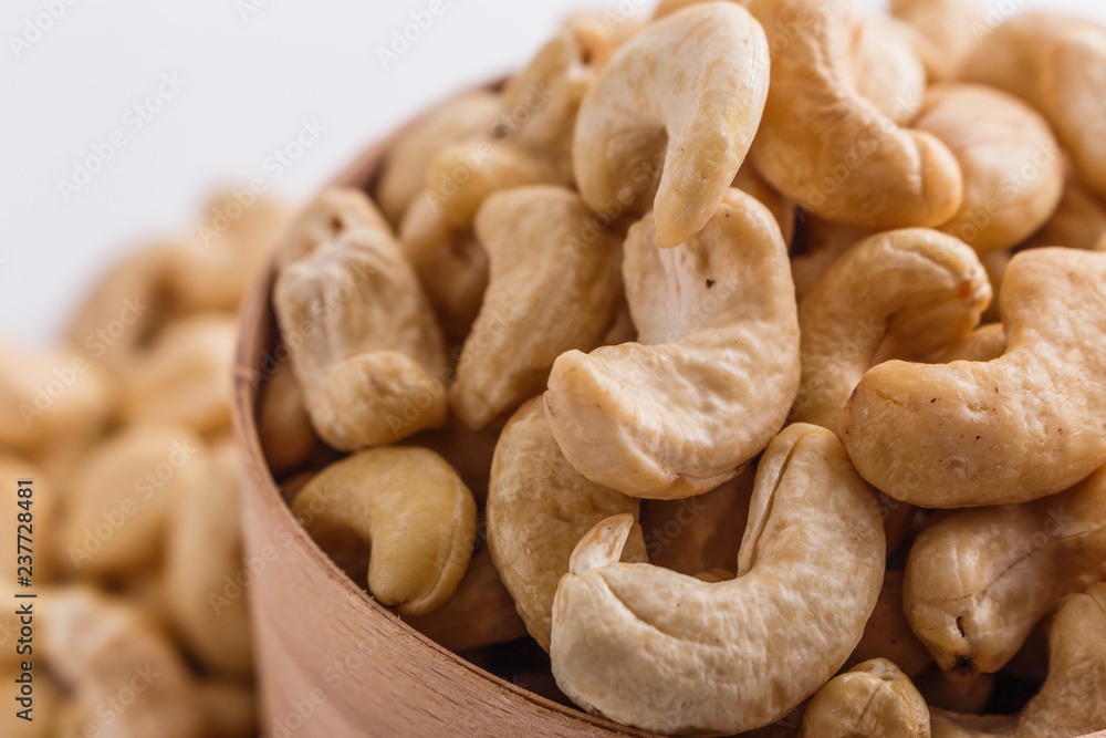cashew nuts on a white acrylic background cashew nuts on a white acrylic background
