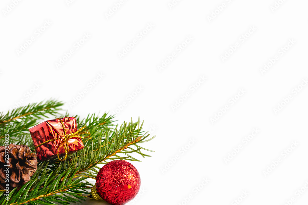 Spruce, fir tree branches with Christmas decorations on white background with copy space