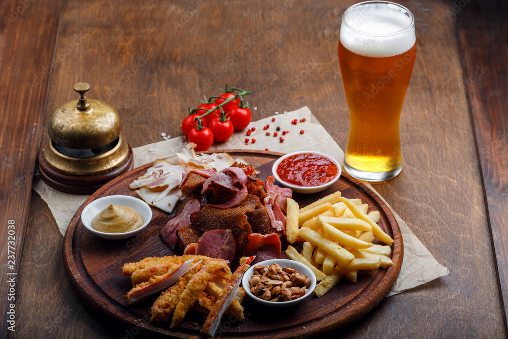 Big set of snacks for beer or alcohol and it includes smoked pork meat, french fries, fried bread, crab sticks and nuts Big set of snacks for beer or alcohol and it includes smoked pork meat, french fries, fried bread, crab sticks and nuts