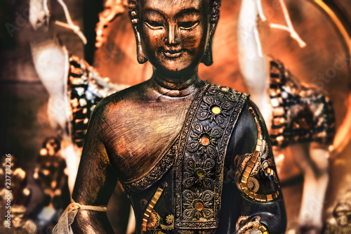 buddha meditating yoga background bronze orange statue photo