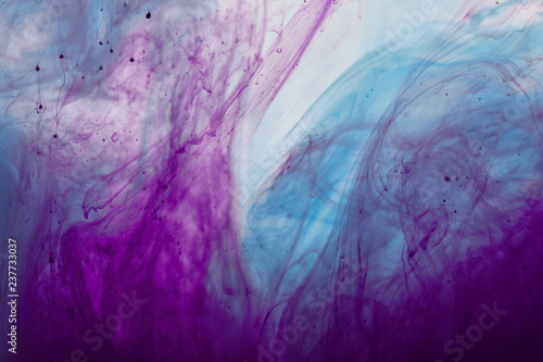 abstract background with purple and blue mixing swirls of paint