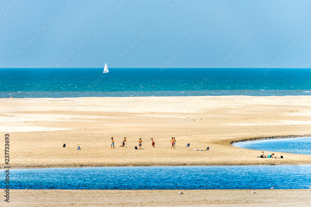 Fototapeta premium Boys playing soccer on the beach
