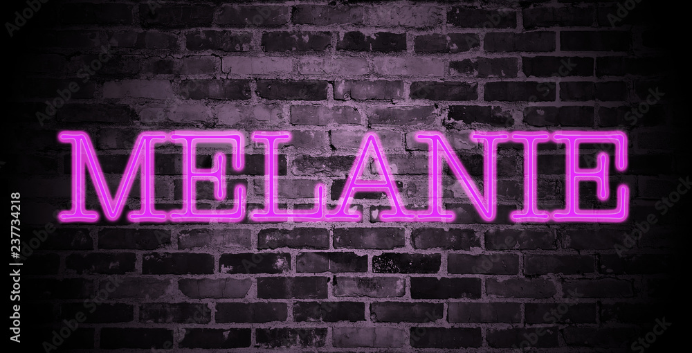Fototapeta premium first name Melanie in pink neon on brick wall