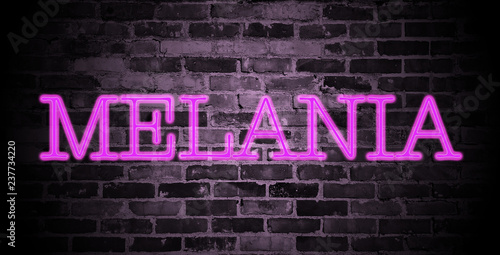 first name Melania in pink neon on brick wall