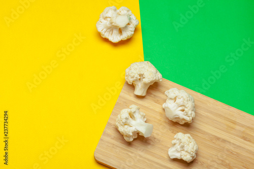 Cauliflower pieces on a bright yellow background