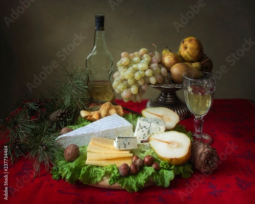 Christmas table with cheese and fruits photo