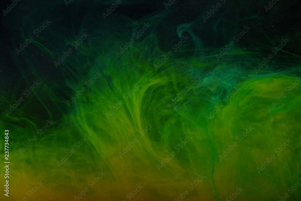 abstract background with green swirls of acrylic paint in water