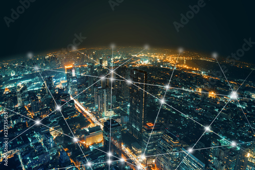 Network and Connection technology night city background at business center bangkok thailand. Wireless skyline connection with energy light infographic.