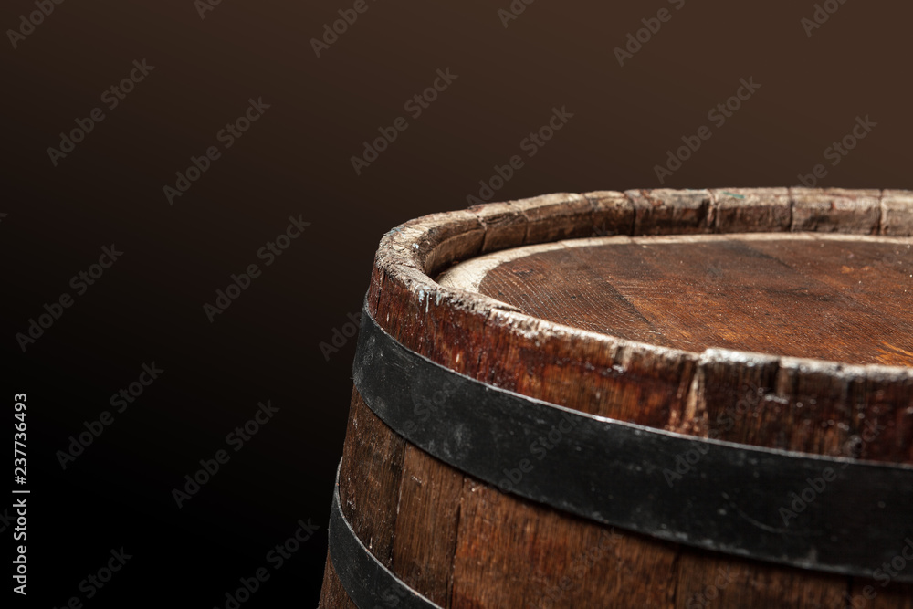 Old wooden barrel on a dark background Old wooden barrel on a dark background