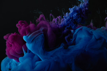 abstract dark texture with blue and purple swirls of paint