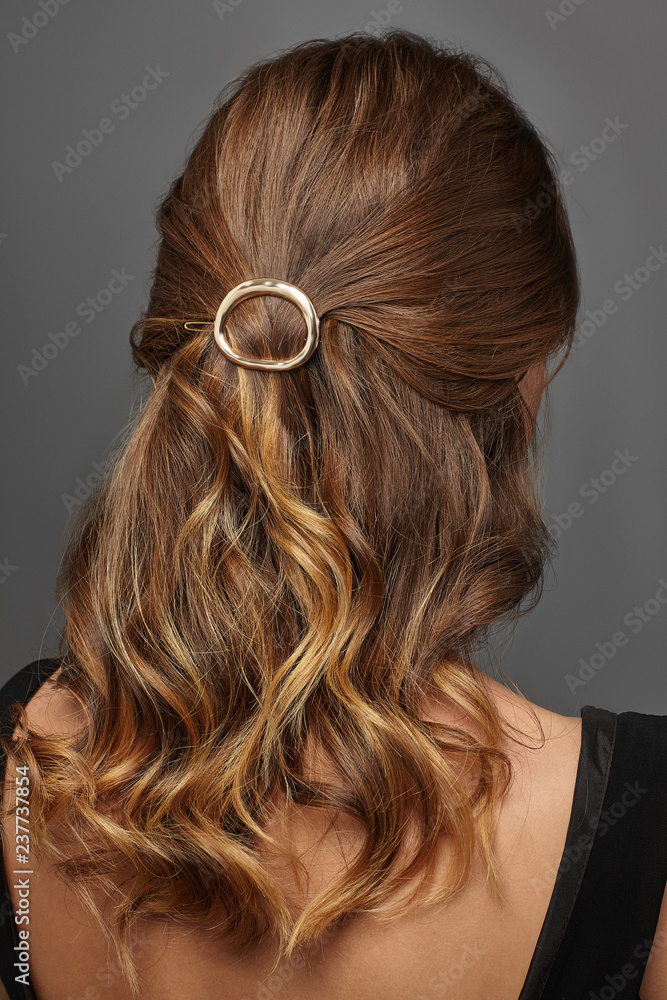 Close up isolated portrait of a young lady with brown ombre hair colour. The back view Close up isolated portrait of a young lady with brown ombre hair colour. The back view