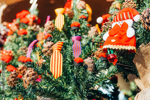 Photography traditional spanish flag colors on christmas pine tree in market among decoratio