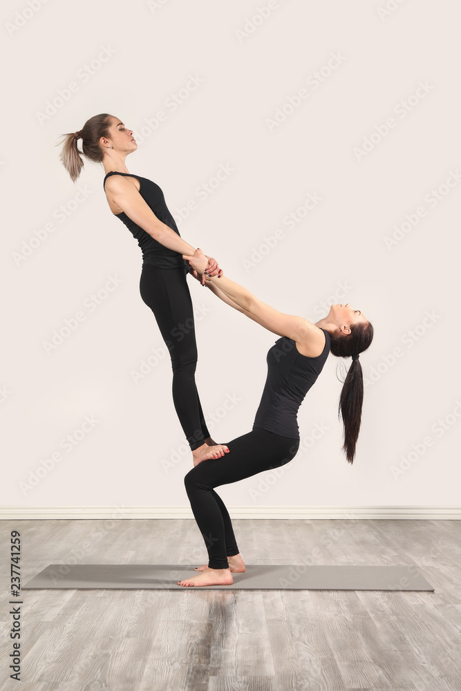 Two slim girls are doing yoga Two slim girls are doing yoga