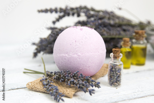 Natural cosmetics. Handmade lavender bath bombs and lavender flowers on white wooden planks