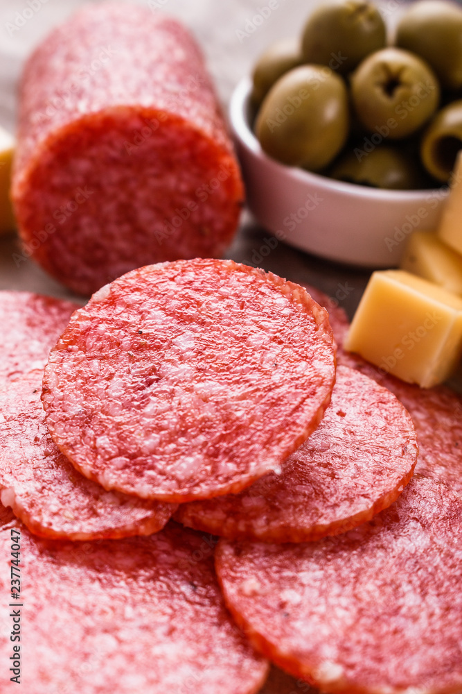 delicious sliced salami on a wooden background delicious sliced salami on a wooden background