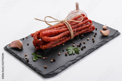 kabanos delicious polish snack sausage on a stone plate white background