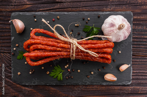kabanos delicious polish snack sausage on a stone plate wooden background photo