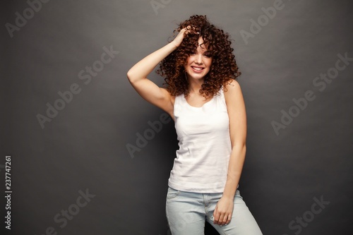people, style and fashion concept - happy young woman or teen girl in casual clothes having fun. © opolja