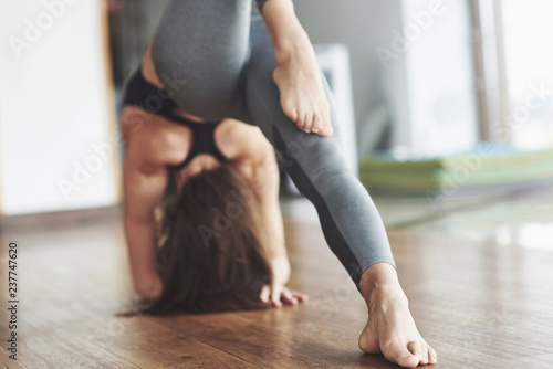 A beautiful yoga woman practicing in a spacious light gym