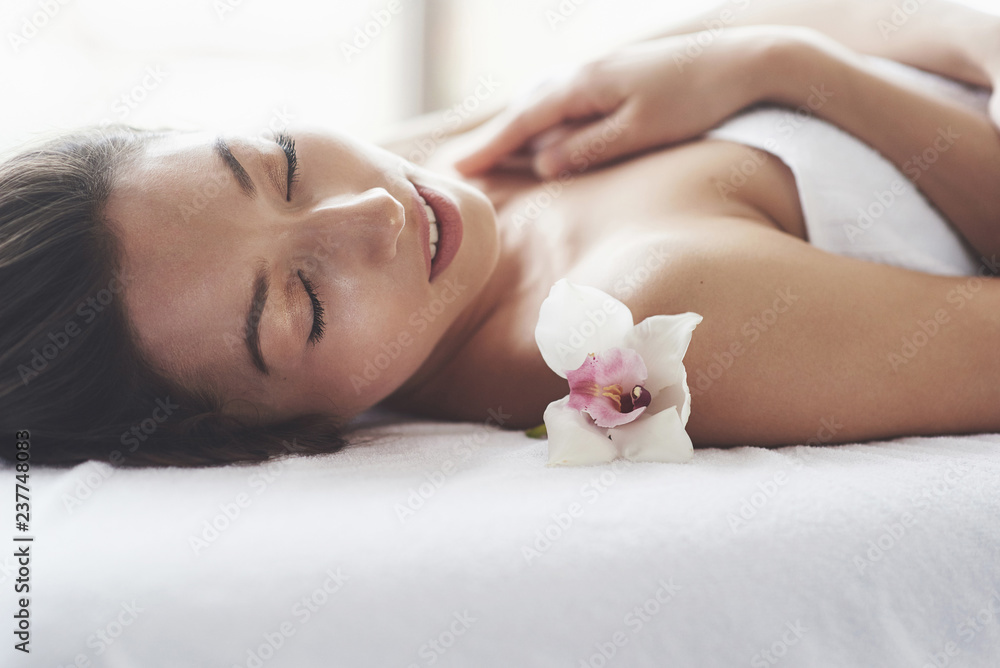 beautiful girl with an orchid perfect skin near the big window. beautiful girl with an orchid perfect skin near the big window.