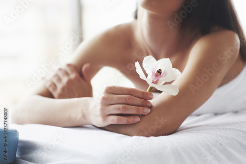 Beautiful body woman with white flower orchid and body care.
