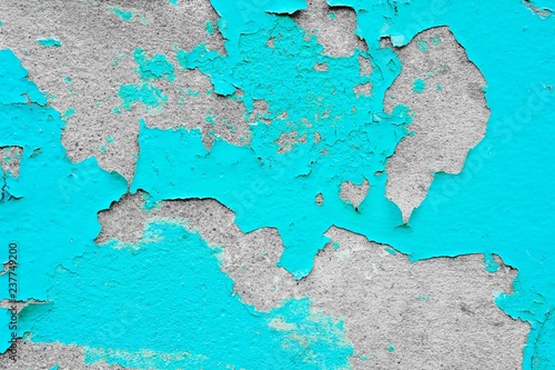 the blue old paint texture is chipping and cracked at the wall