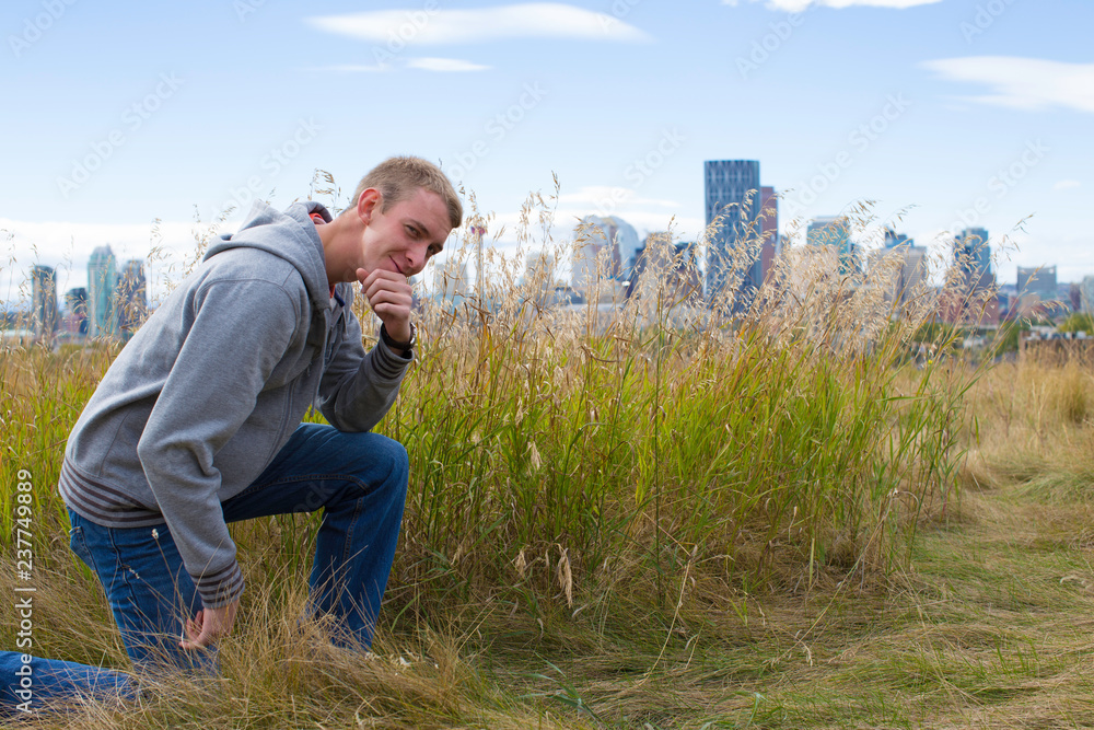 young man kneeling in grass