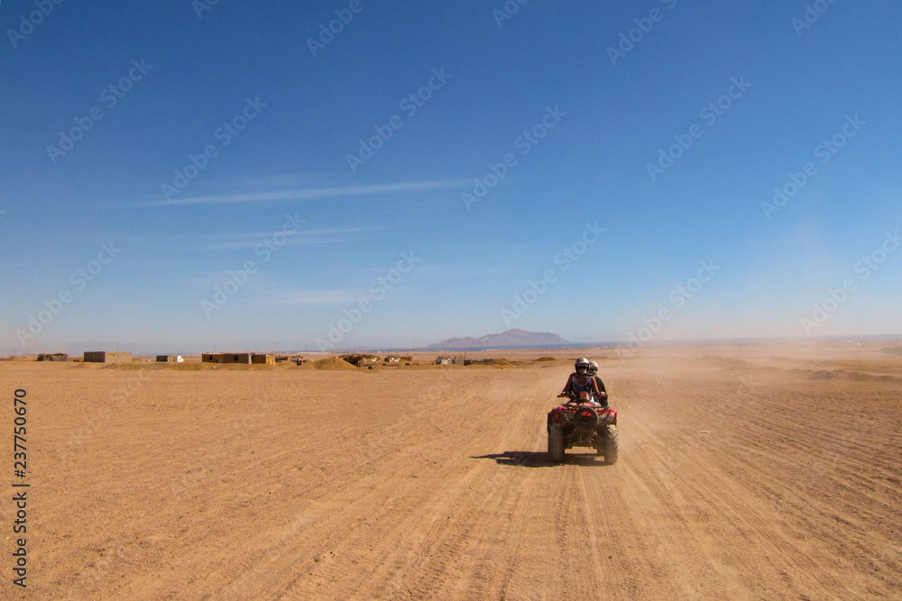 a couple in love travels through the desert on a Quad bike a couple in love travels through the desert on a Quad bike