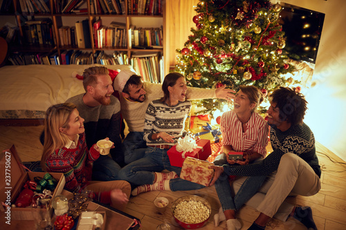 friends laughing and sharing Christmas gifts.. photo