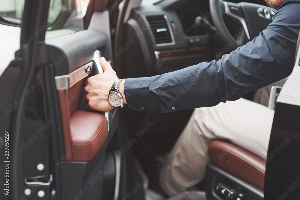 Beautiful young man in full suit while driving a car Beautiful young man in full suit while driving a car