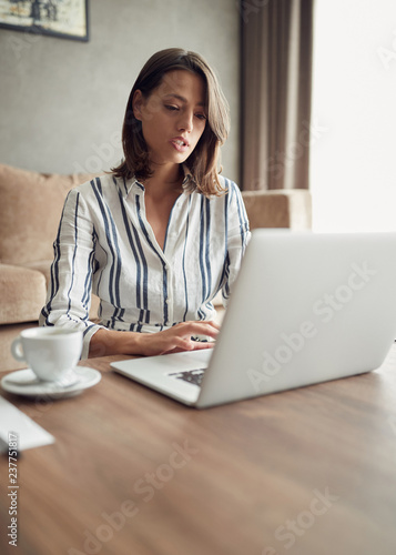 Working home concept -Woman using a laptop computer for work at home.