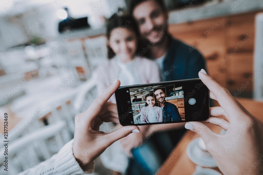 Mother Photographs Dad with Daughter on Cellphone Mother Photographs Dad with Daughter on Cellphone