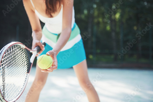 A pretty woman wearing a sportswear tennis court on the court © standret