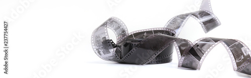 Old photographic film in a roll on a light background. The concept of history, home archives, memorable dates. Selective focus, close-up.