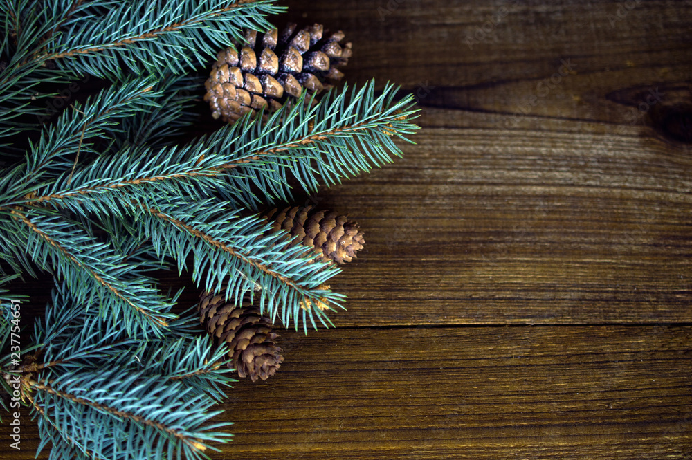 Fir branches and cones on wooden background Fir branches and cones on wooden background