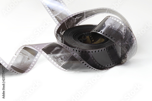 Old photographic film in a roll on a light background. The concept of history, home archives, memorable dates. Selective focus, close-up.