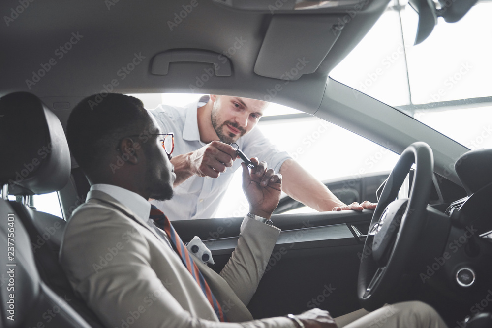 Young black businessman test drive new car. Rich african american man Young black businessman test drive new car. Rich african american man