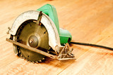 circular saw or power saw on wooden background tool woodcraft object isolated
