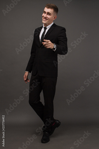 young man in elegant suit posing. Business style. Male beauty, fashion. Hairstyle.