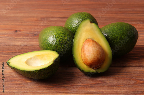  Avocado fruit on wooden table top view.
