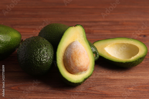 Avocado fruit on wooden table top view.