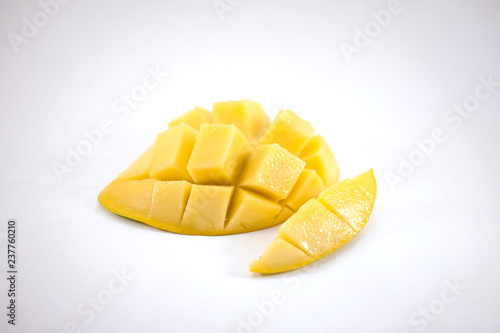 Yellow mango slice with cubes isolated white background