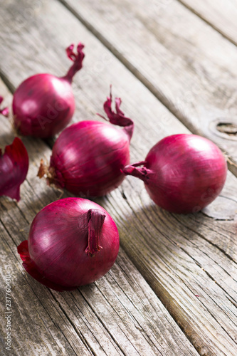 spanish onions on old rustic wood table background