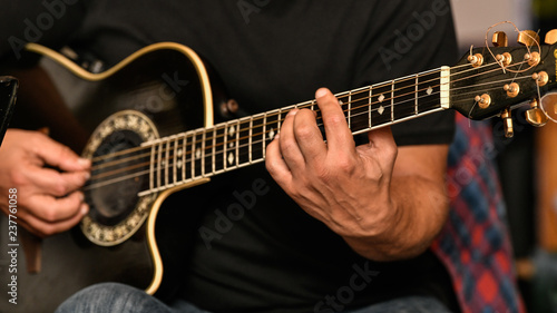Closeup of a musician playing the guitar live at a greek restaurant