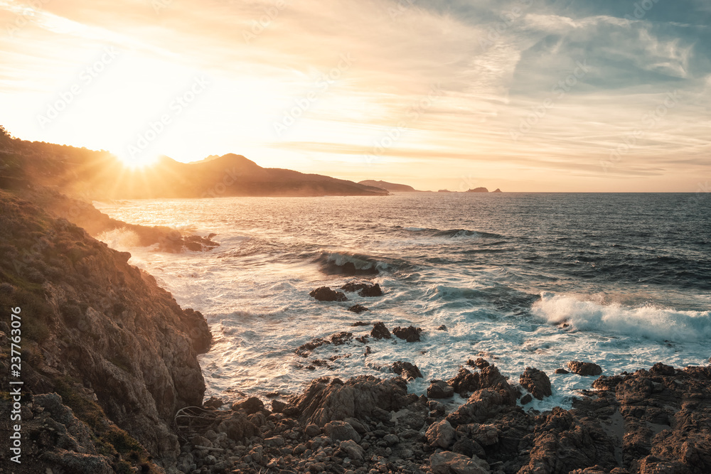 Sunset and rough sea on the coast of Corsica