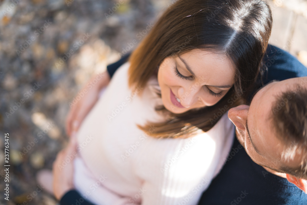 Young couple expecting baby, smiling and hugging her tummy. Young couple expecting baby, smiling and hugging her tummy.
