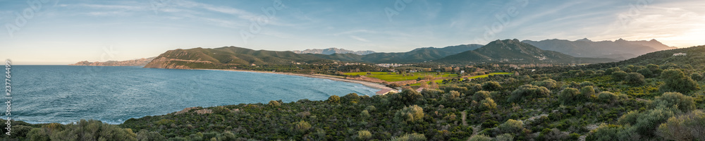 Panoramic view of Lozari beach and distant mountains in Corsica