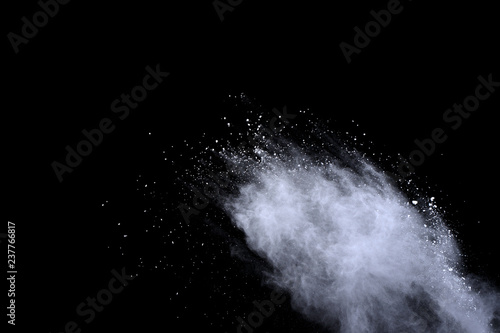 Fototapeta Naklejka Na Ścianę i Meble -  White powder explosion on black background. Dust splatted isolated. Paint Holi.